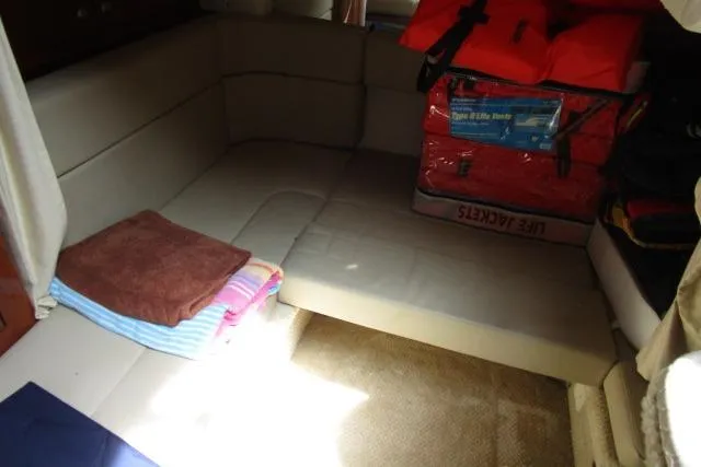 Slide: The Image of Interior cabin of 2006 Sea Ray Sundancer 320 with seating, towels, and life jackets. - 11