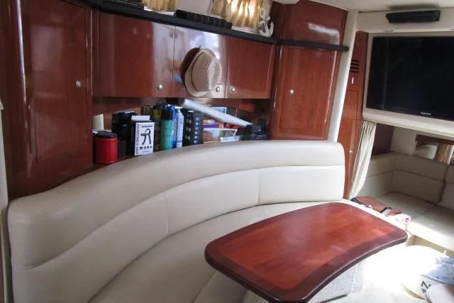 Slide: The Image of Interior of 2006 Sea Ray Sundancer 320 with leather seating and wooden table. - 16