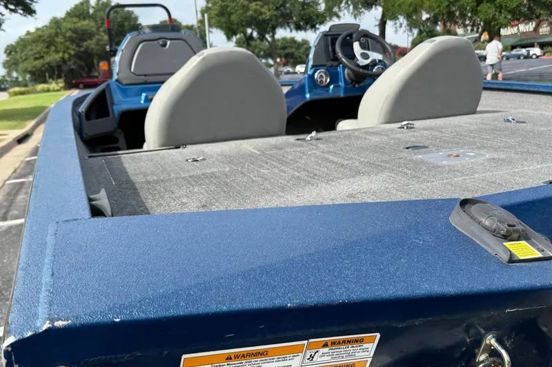 Slide: The Image of 2018 Xpress X19 Pro boat interior with gray seats and steering wheel. - 3