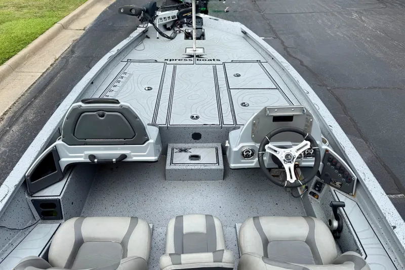 Slide: The Image of 2018 Xpress X21 Pro boat interior with steering wheel and seating, showcasing modern design. - 16