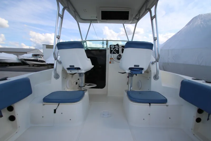 Slide: The Image of 2002 Hydra-Sports 230 WA boat interior with blue seating and steering console. - 12