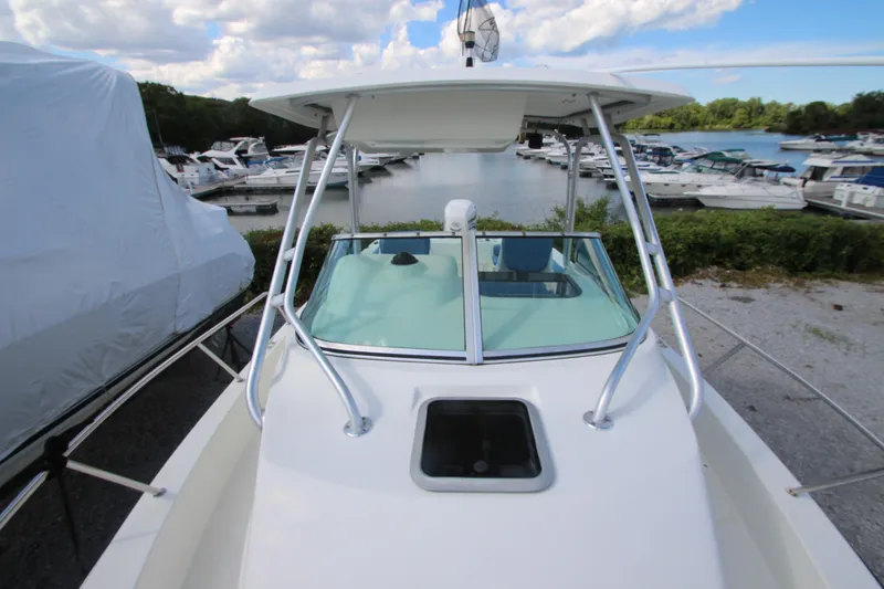 Slide: The Image of 2002 Hydra-Sports 230 WA boat docked at marina with clear sky and water view. - 17