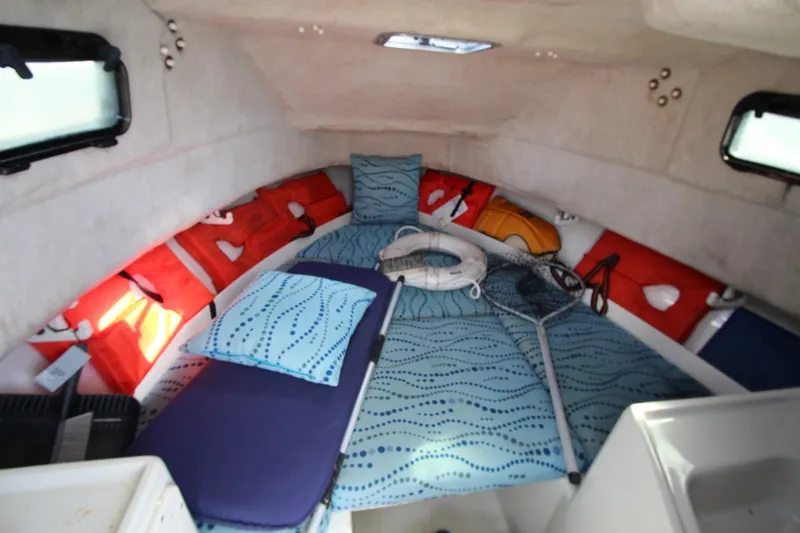 Slide: The Image of Interior cabin of 2002 Hydra-Sports 230 WA boat with life jackets and fishing gear. - 19