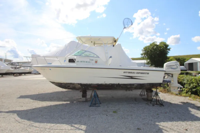 Slide: The Image of 2002 Hydra-Sports 230 WA boat on stands, outdoor storage, clear sky background. - 2