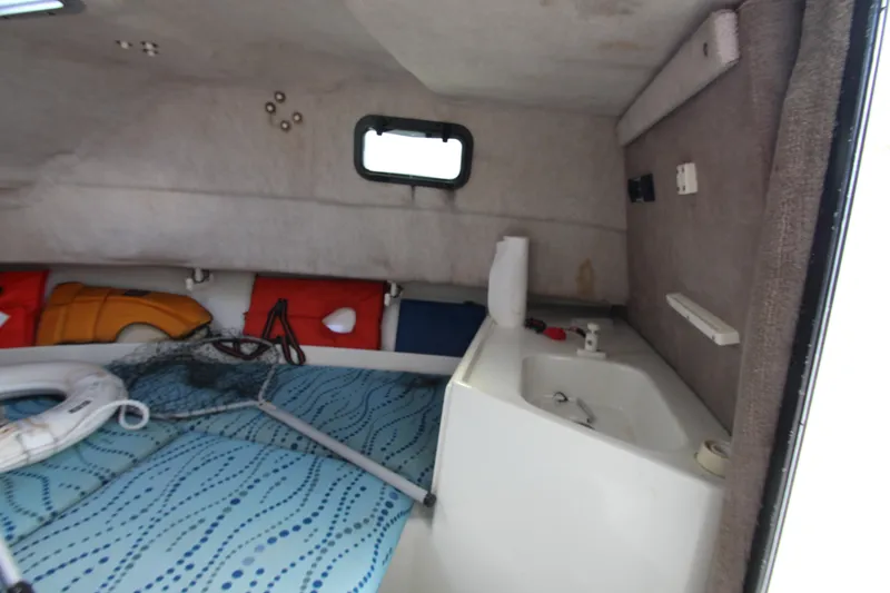 Slide: The Image of Interior cabin of 2002 Hydra-Sports 230 WA boat with sink and safety equipment. - 20