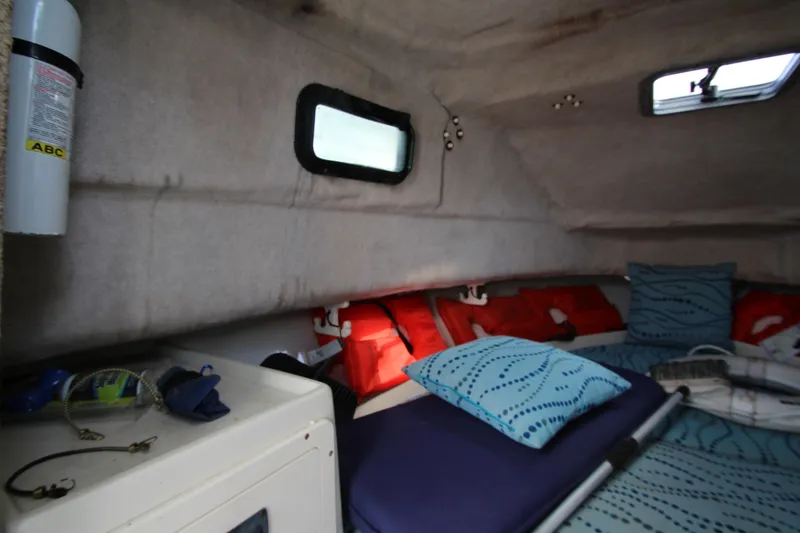 Slide: The Image of Interior cabin of 2002 Hydra-Sports 230 WA boat with cushions and safety equipment. - 21