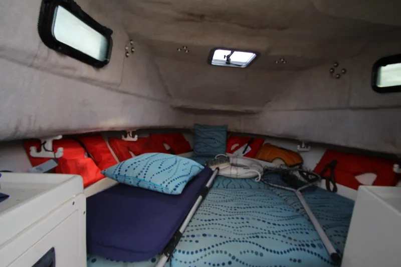 Slide: The Image of Interior cabin of 2002 Hydra-Sports 230 WA boat with bedding and fishing gear. - 22