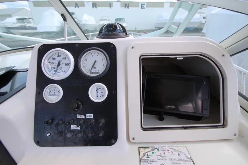 Slide: The Image of Dashboard of a 2002 Hydra-Sports 230 WA boat with gauges and Garmin GPS. - 23