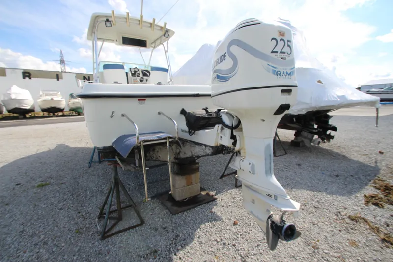 Slide: The Image of 2002 Hydra-Sports 230 WA boat with outboard motor on display in a marina. - 3