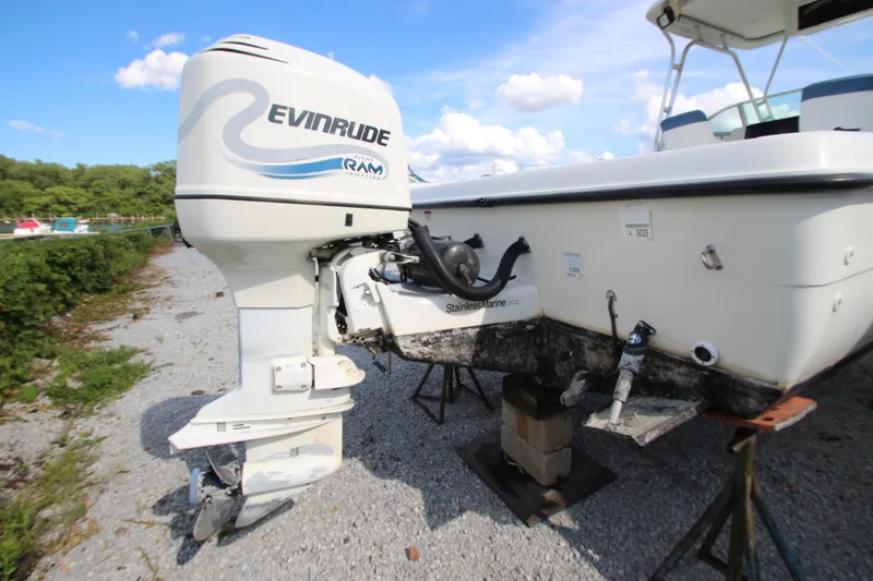 Slide: The Image of 2002 Hydra-Sports 230 WA boat with Evinrude outboard motor on gravel surface. - 4