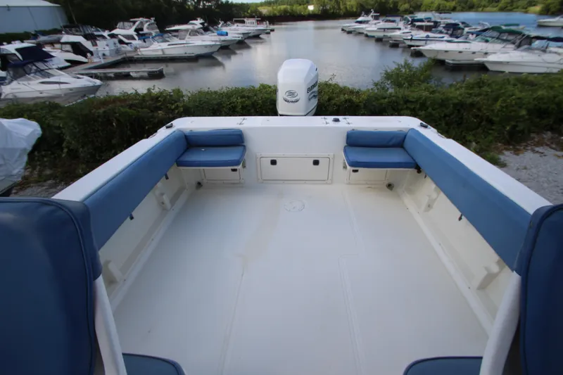 Slide: The Image of 2002 Hydra-Sports 230 WA boat interior with blue seating, docked at marina. - 8