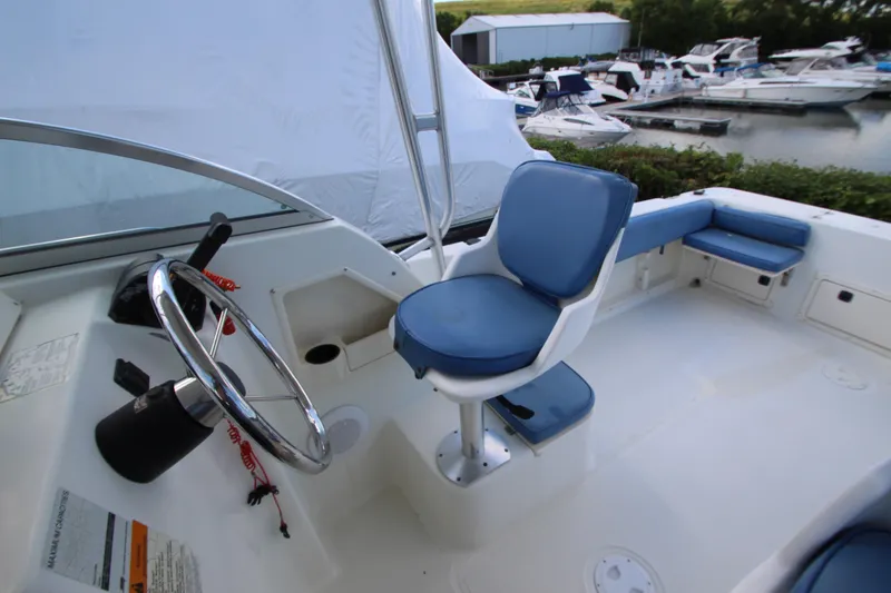 Slide: The Image of 2002 Hydra-Sports 230 WA boat interior with blue seating and steering wheel. - 9