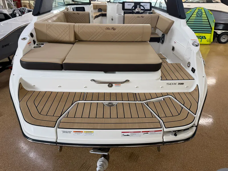 Slide: The Image of The image shows the stern of a 2026 Sea Ray SDX 230 boat with beige upholstery. - 8