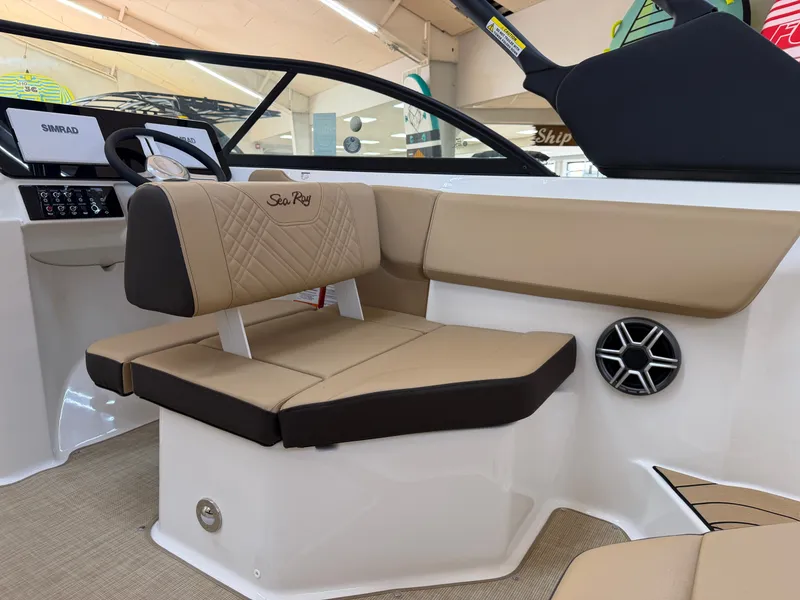 Slide: The Image of The image shows the interior of a Sea Ray SDX 230 boat with beige upholstery and modern controls. - 24