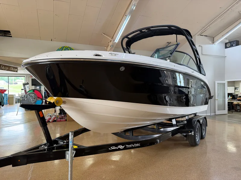 Slide: The Image of A 2026 Sea Ray SDX 230 boat on a trailer in a showroom. - 3