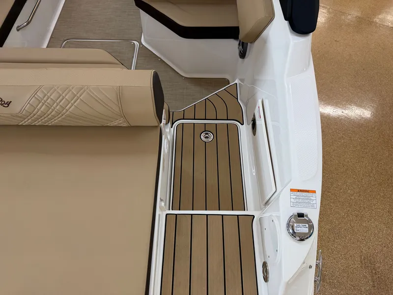 Slide: The Image of The image shows the deck of a Sea Ray SDX 230 boat with elegant wood flooring and beige upholstery. - 15