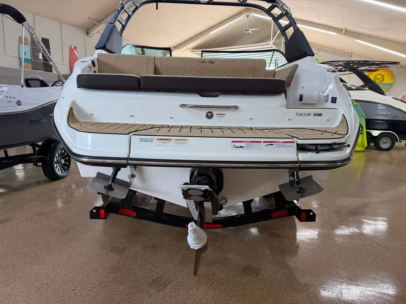 Slide: The Image of The image shows the rear of a 2026 Sea Ray SDX 230 boat in a showroom. - 5