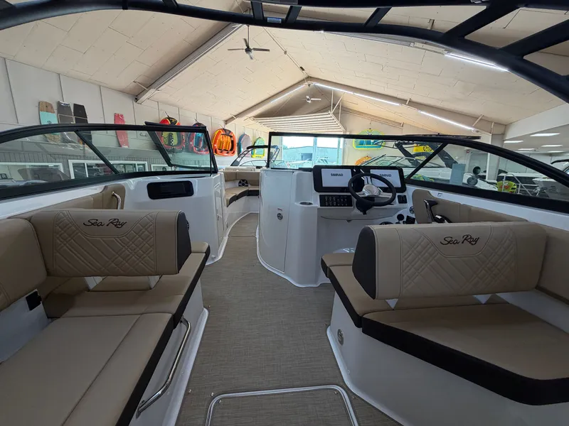 Slide: The Image of Interior of a Sea Ray SDX 230 boat with beige seating and modern helm console. - 26