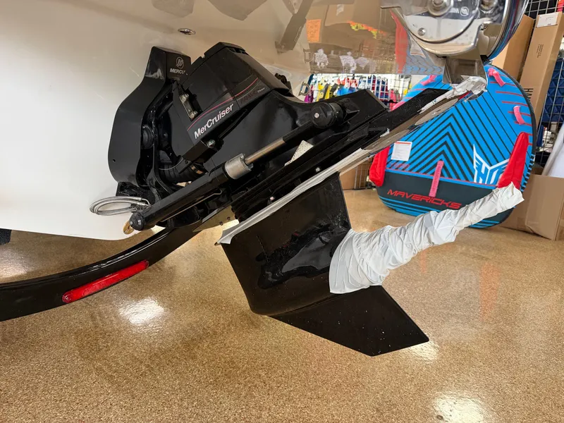 Slide: The Image of A 2026 Sea Ray SDX 230 showing its MerCruiser drive. A colorful surfboard is visible in the background. - 6