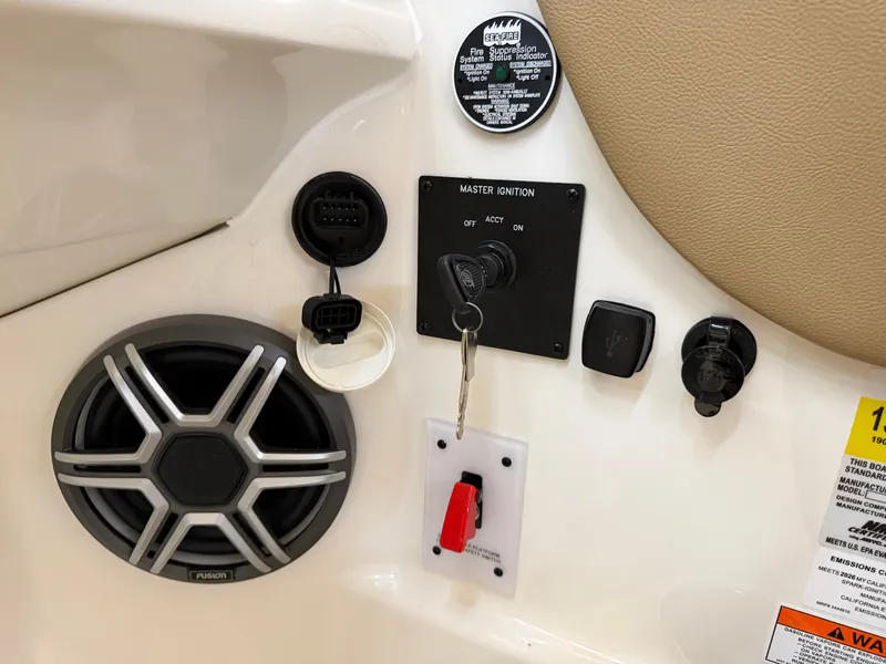 Slide: The Image of Close-up of a Sea Ray SDX 230 dashboard with speaker and ignition key. - 32