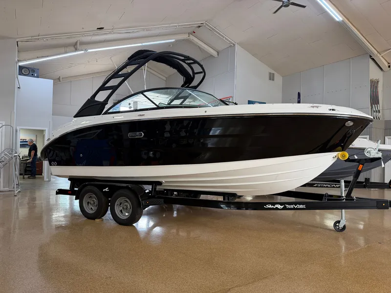 Slide: The Image of 2026 Sea Ray SDX 230 on a trailer inside a showroom. - 1