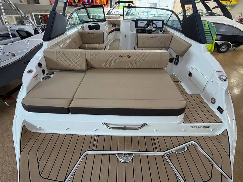 Slide: The Image of The image shows the stern of a 2026 Sea Ray SDX 230 boat with beige upholstery. - 10
