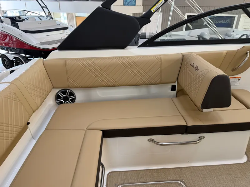Slide: The Image of The 2026 Sea Ray SDX 230 features luxurious beige upholstery with elegant stitching. - 22