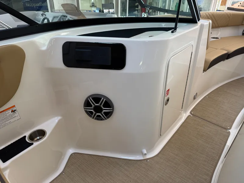 Slide: The Image of The image shows the interior of a 2026 Sea Ray SDX 230 boat with beige seating. - 37