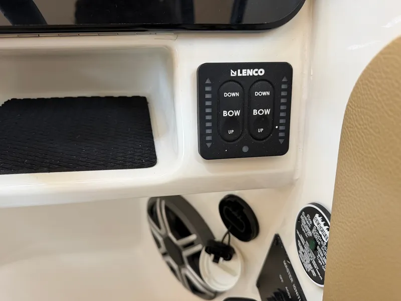 Slide: The Image of Close-up of a control panel with Lenco trim tab controls on a Sea Ray SDX 230 boat. - 31