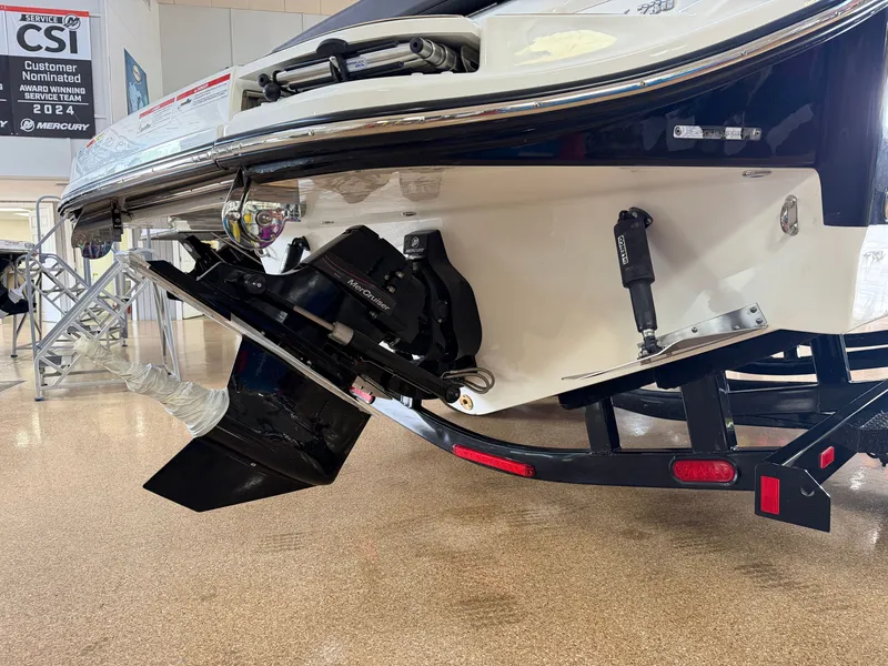 Slide: The Image of The image shows the stern of a Sea Ray SDX 230 boat with an outboard motor. - 7