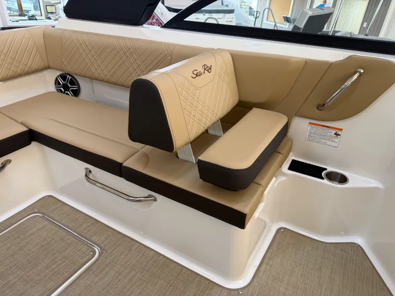 Slide: The Image of The image shows the interior of a Sea Ray SDX 230 boat with beige upholstery and elegant stitching. - 36