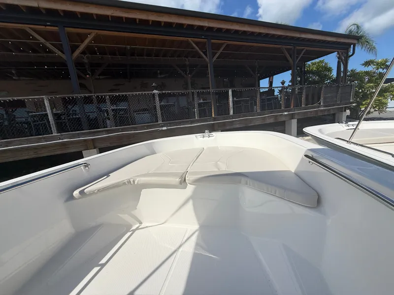 Slide: The Image of The image shows the bow area of a 2027 Boston Whaler 160 Super Sport with white cushions. - 5