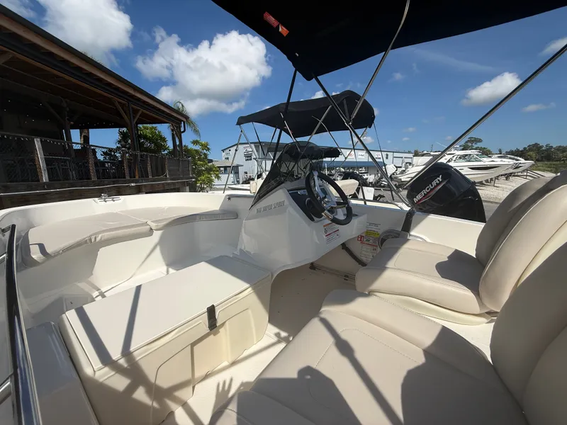 Slide: The Image of The image shows a Boston Whaler 160 Super Sport boat with beige seats and a black sunshade. - 10