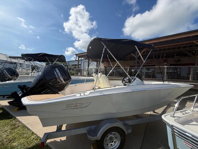 Slide: The Image of A 2027 Boston Whaler 160 Super Sport on a trailer. It features a black sunshade. - 2