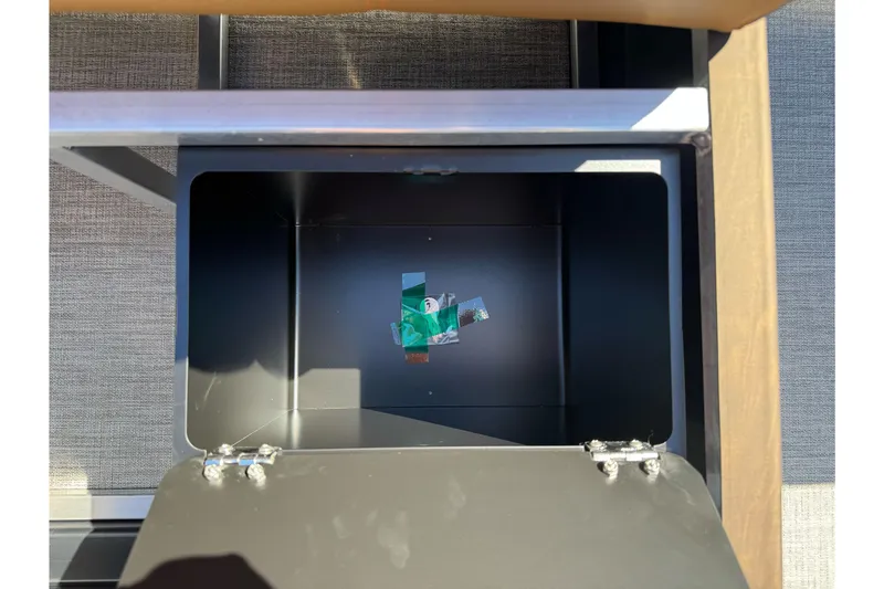 Slide: The Image of Open storage compartment on 2026 Tahoe Pontoon Geofish RF 21 boat. - 24