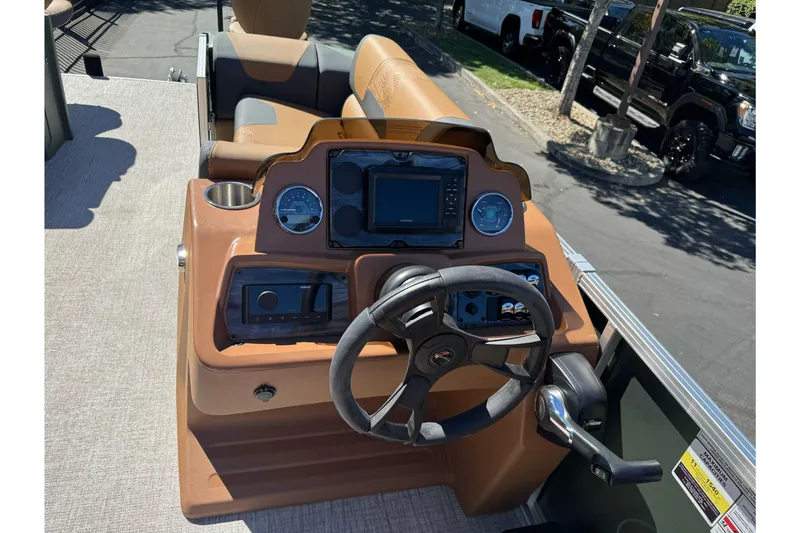 Slide: The Image of 2026 Tahoe Pontoon Geofish RF 21 dashboard with steering wheel and control panel. - 25
