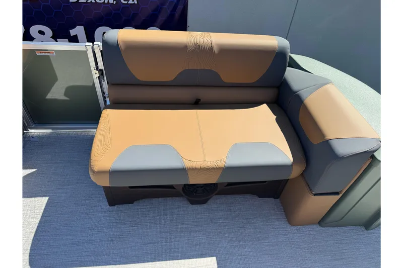 Slide: The Image of 2026 Tahoe Pontoon Geofish RF 21 seating, featuring tan and gray upholstery on a boat deck. - 30
