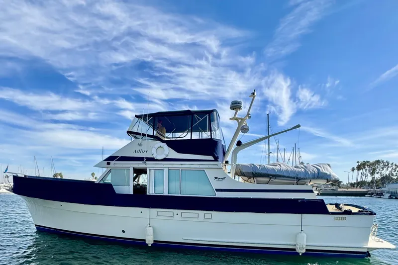 The Image of 1985 Tollycraft 48 Cockpit Motor Yacht on calm water under blue sky. - 0
