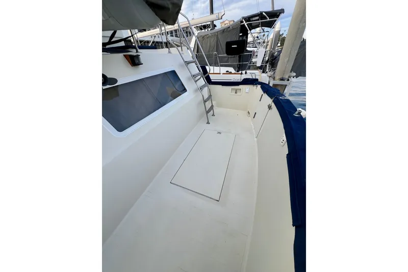 Slide: The Image of 1985 Tollycraft 48 Cockpit Motor Yacht deck with ladder and window view. - 14