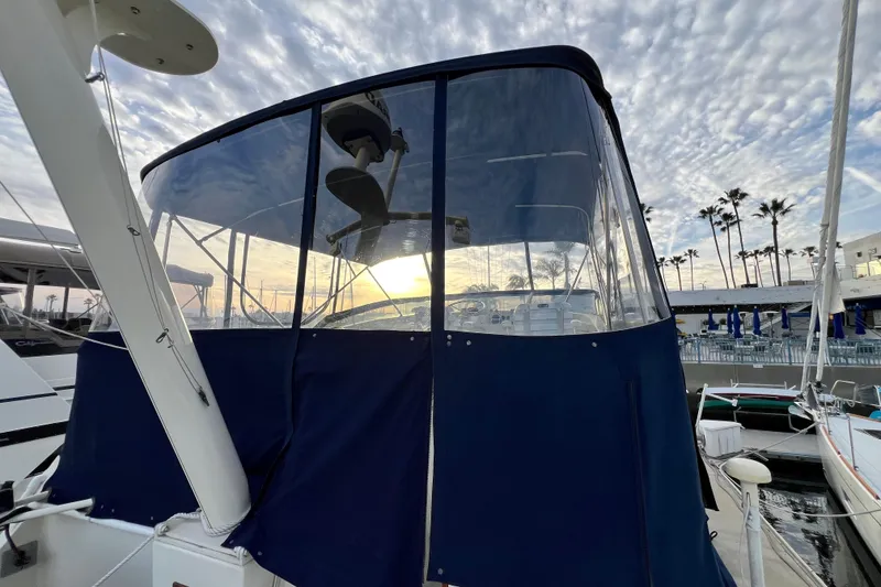 Slide: The Image of 1985 Tollycraft 48 Cockpit Motor Yacht at marina, sunset view, blue canopy. - 26