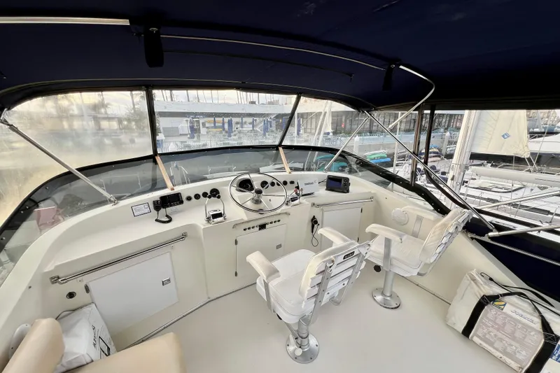 Slide: The Image of 1985 Tollycraft 48 Cockpit Motor Yacht helm with steering wheel and navigation equipment. - 27