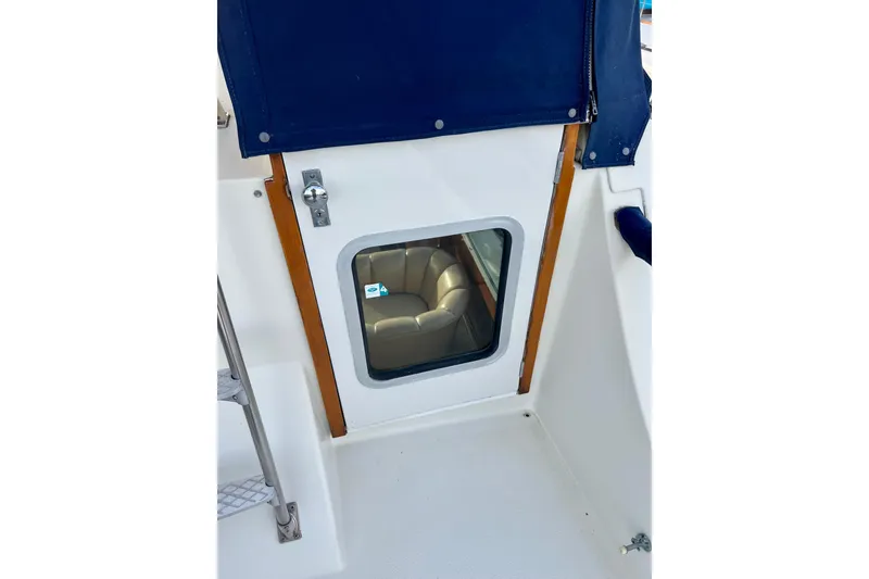 Slide: The Image of 1985 Tollycraft 48 Cockpit Motor Yacht door with window and blue cover. - 35