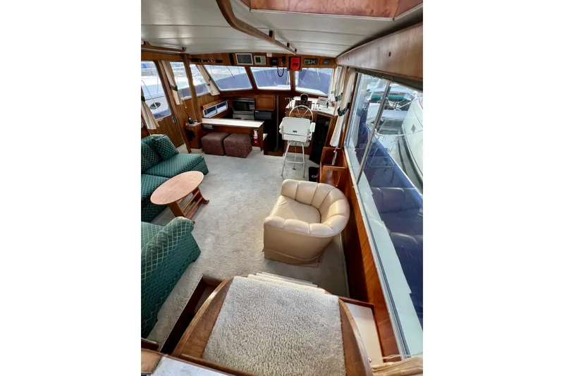 Slide: The Image of Interior of 1985 Tollycraft 48 Cockpit Motor Yacht with plush seating and helm station. - 36