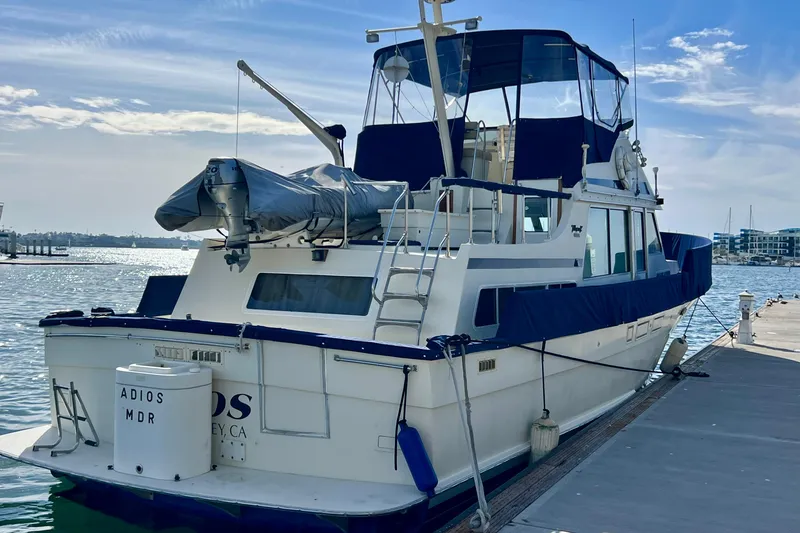 Slide: The Image of 1985 Tollycraft 48 Cockpit Motor Yacht docked at marina under clear sky. - 4