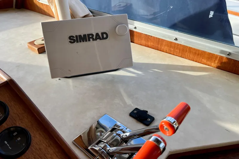 Slide: The Image of Control panel of 1985 Tollycraft 48 Cockpit Motor Yacht with Simrad navigation system. - 44