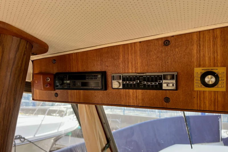Slide: The Image of 1985 Tollycraft 48 Cockpit Motor Yacht interior with vintage audio controls. - 46