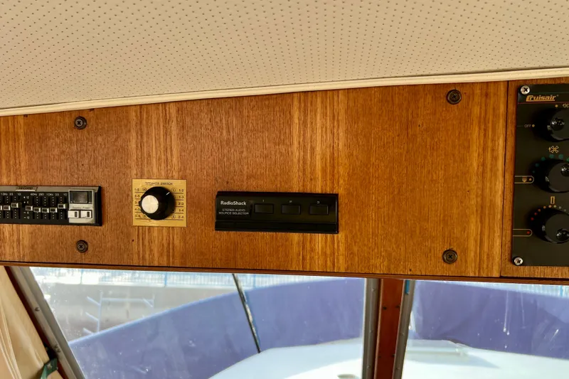 Slide: The Image of Control panel of 1985 Tollycraft 48 Cockpit Motor Yacht with wood finish and audio controls. - 47