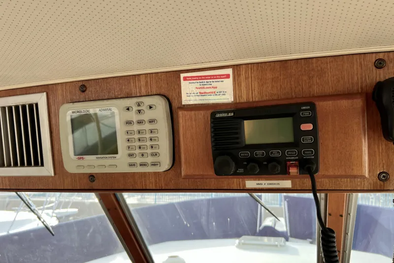 Slide: The Image of Control panel of a 1985 Tollycraft 48 Cockpit Motor Yacht with navigation and communication systems. - 49