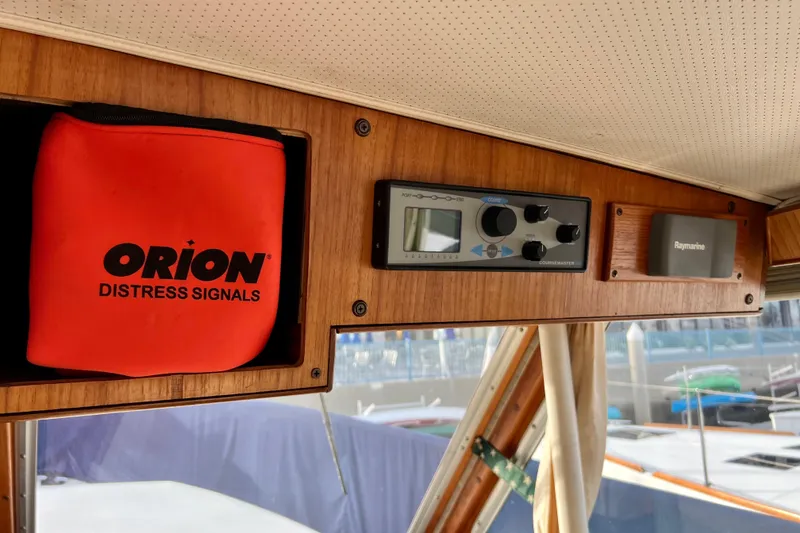 Slide: The Image of 1985 Tollycraft 48 Cockpit Motor Yacht interior with Orion distress signals and navigation equipment. - 50