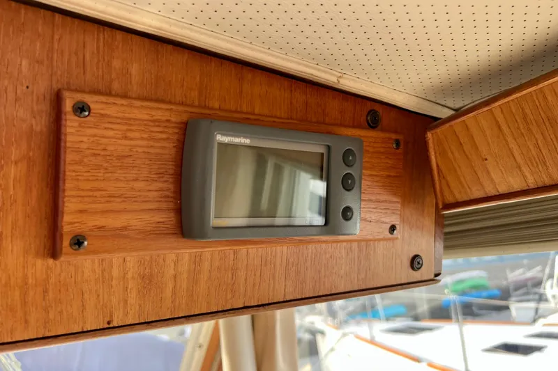 Slide: The Image of Raymarine display on 1985 Tollycraft 48 Cockpit Motor Yacht's wooden interior panel. - 51